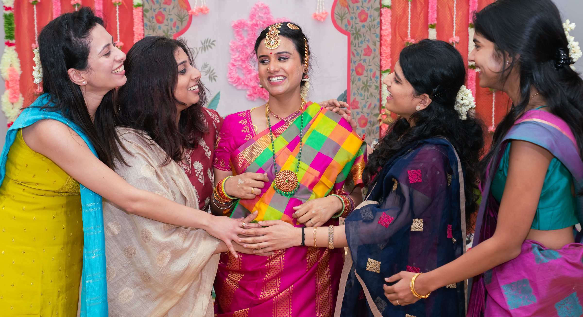 Baavana's traditional south indian baby shower 2024 friends hands on belly laughing