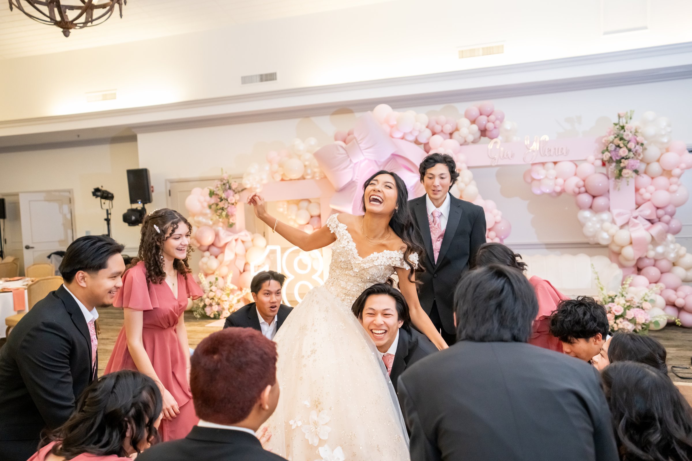 A birthday girl lifted by her court, laughing