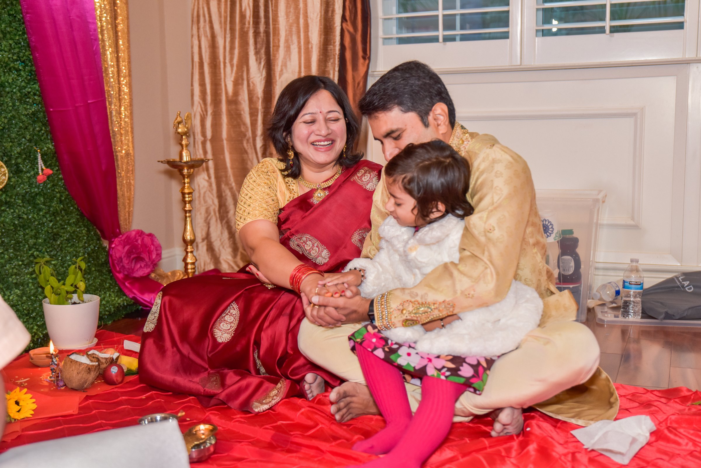 Housewarming abhishek shivaani and mishka grandmother laughing at puja