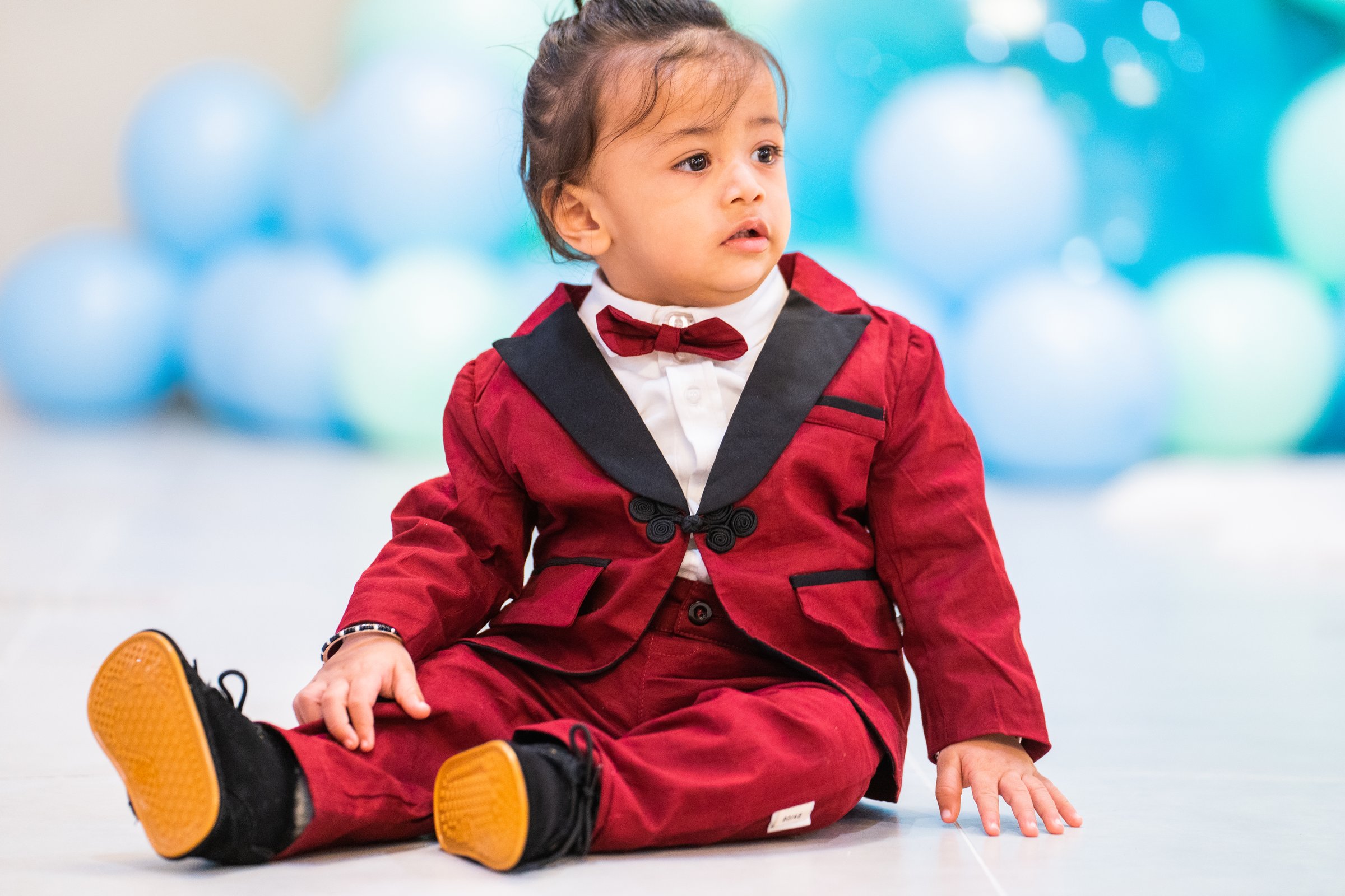 Kiyaansh 1st birthday baby in red tuxedo