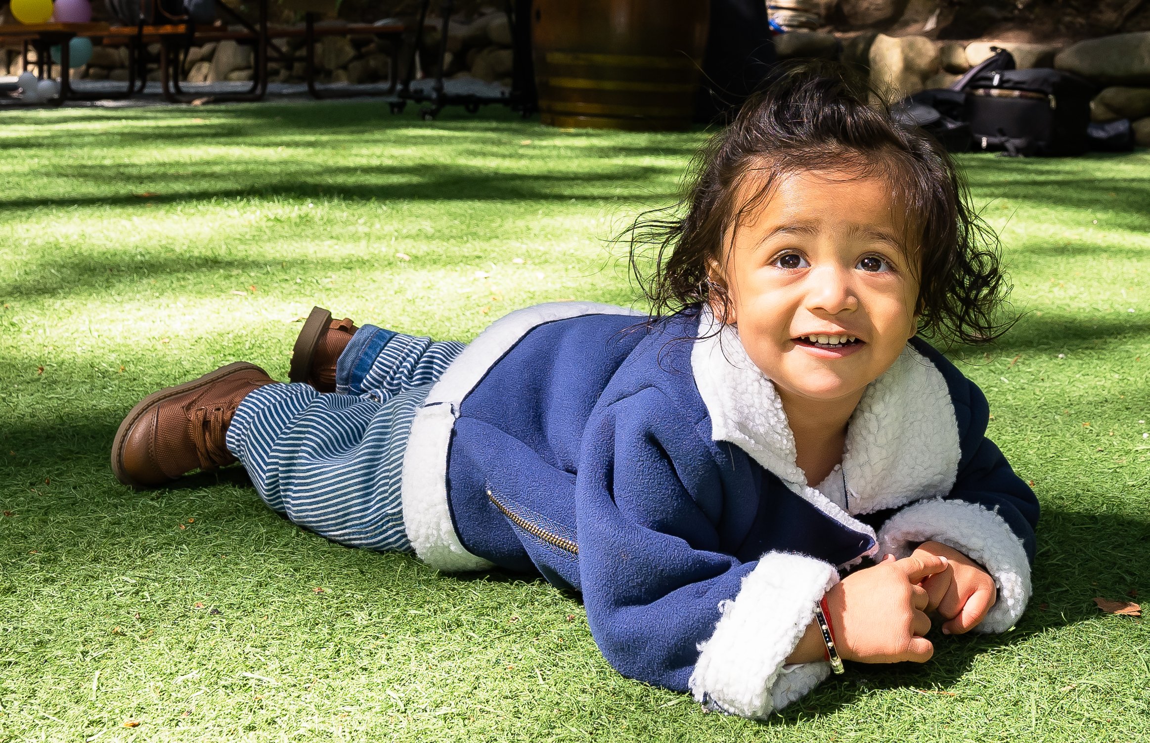 Sia's 3rd birthday toddler lying on the grass