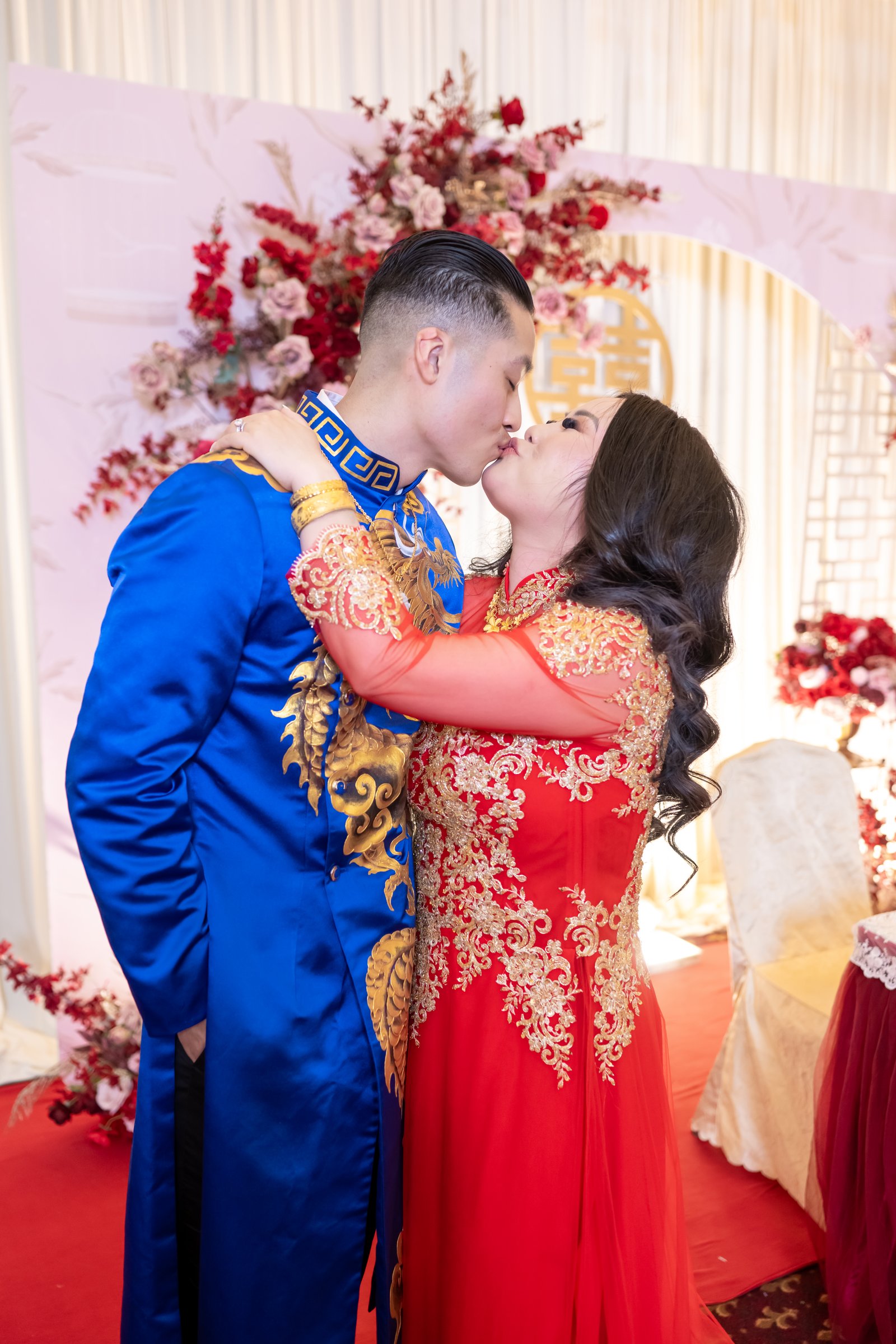 Ashley and kevin's wedding ao dai kiss floral backdrop