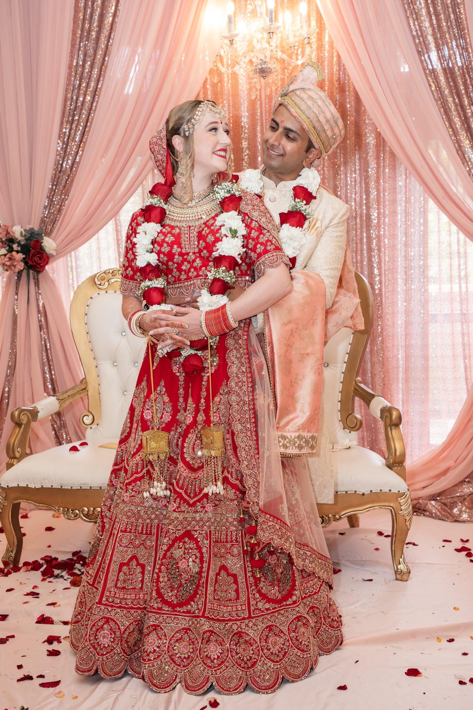 Indian american wedding 2022 embrace among blush drapes