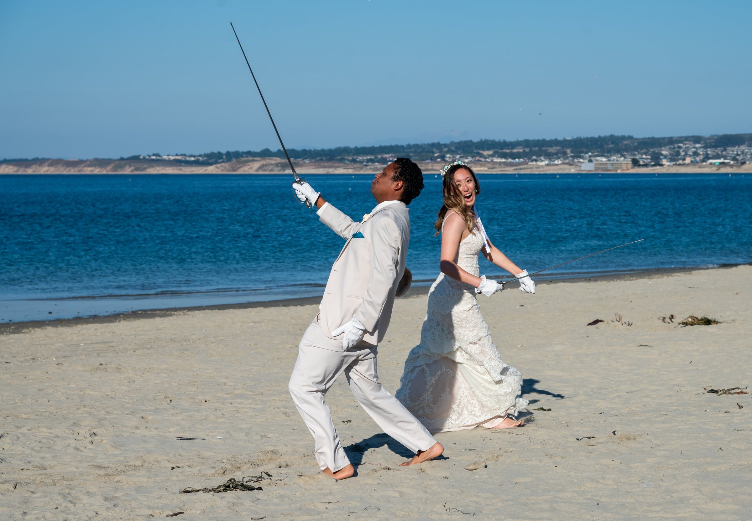 Jessica and jake playful sword lift on beach