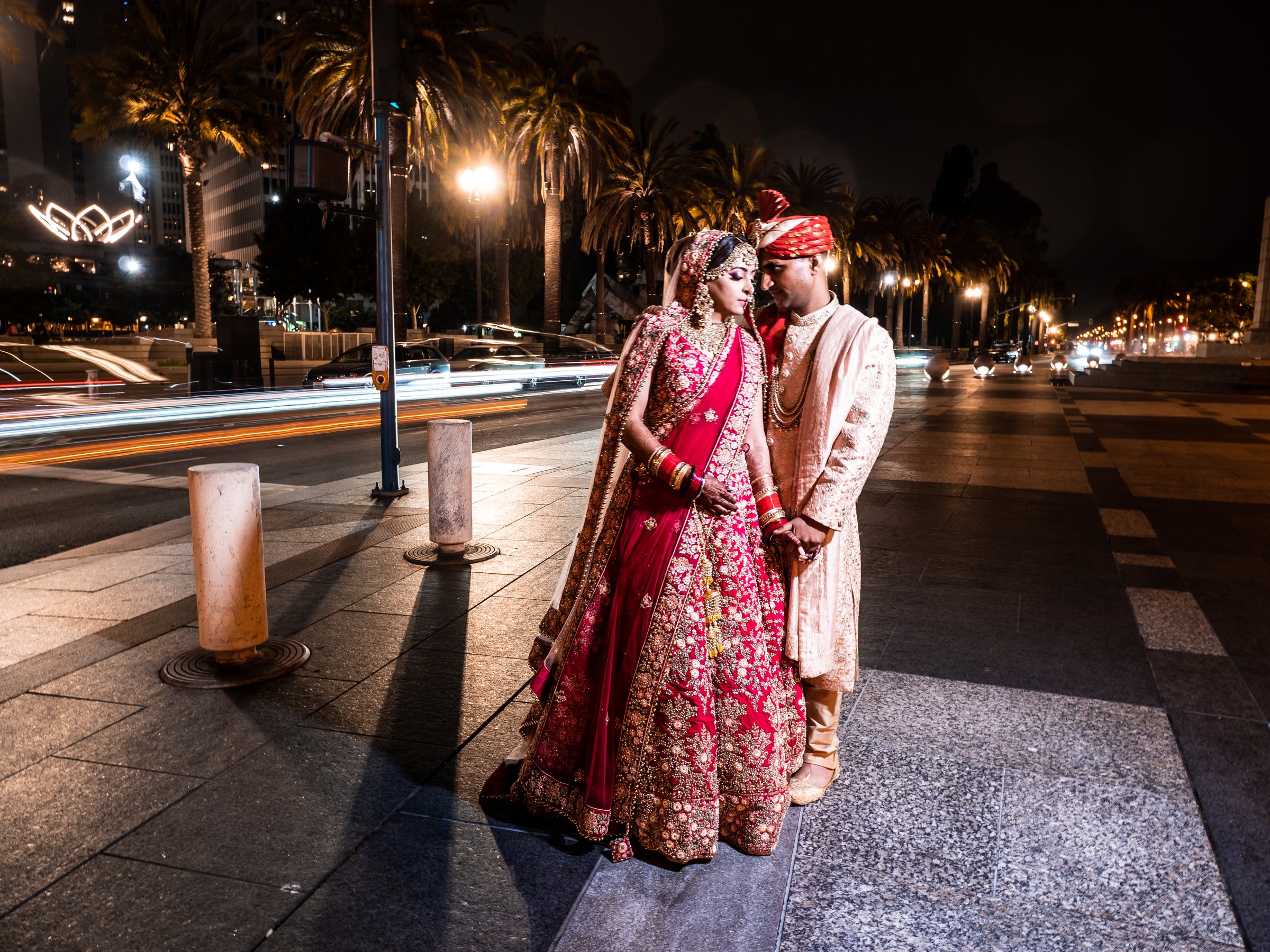 A couple on a night street with light trails