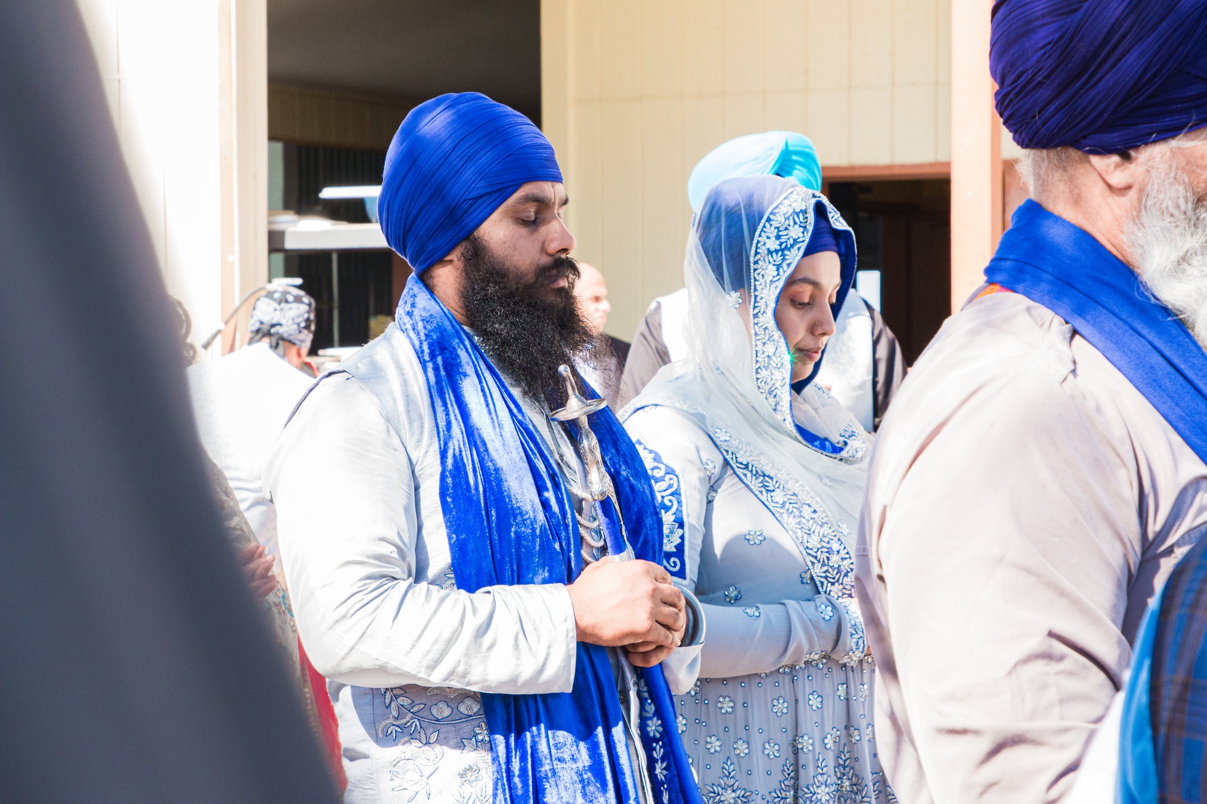 A Gursikh couple in ardas, blue and silver