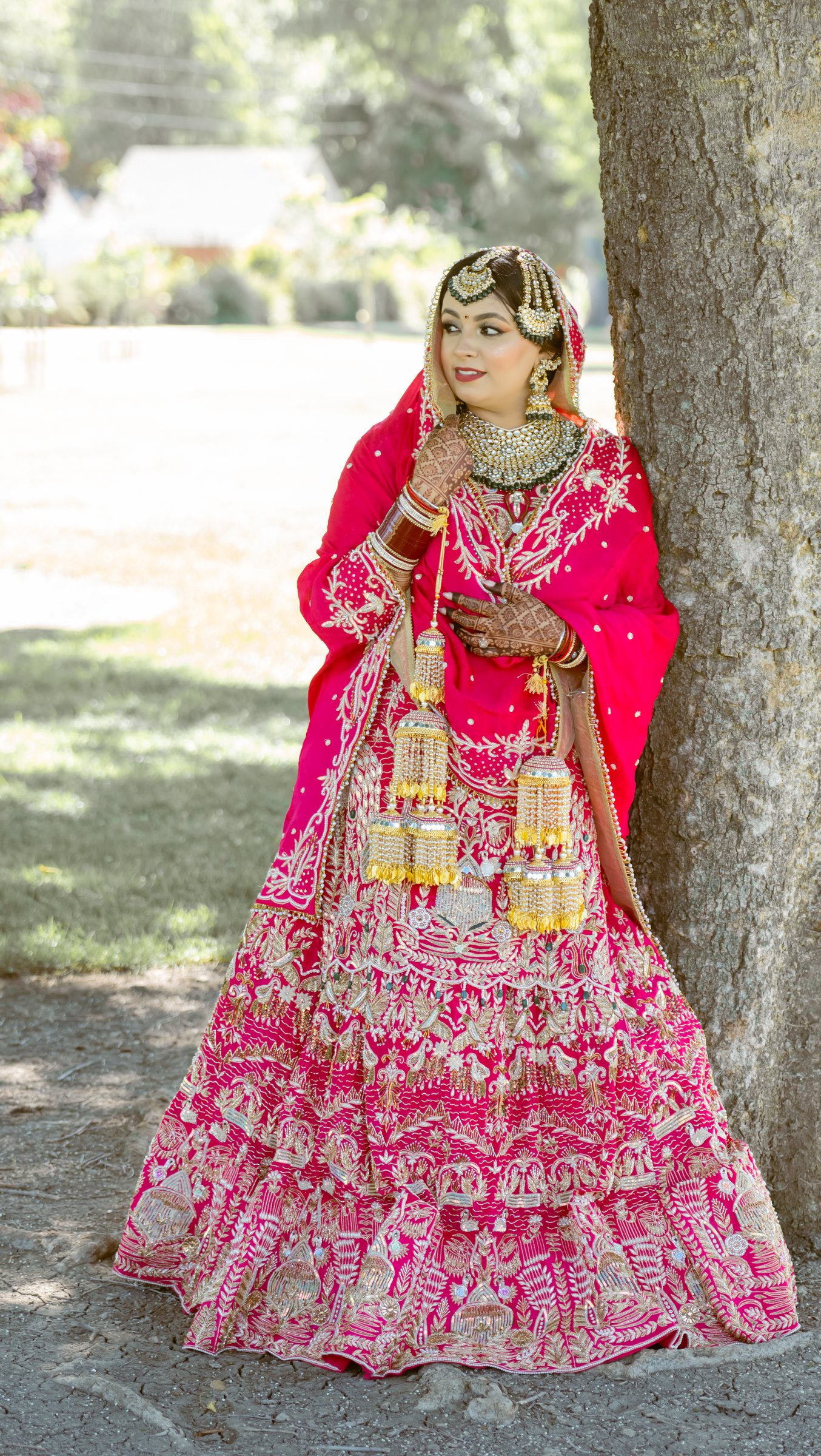 Harpreetandarun bride against oak full length