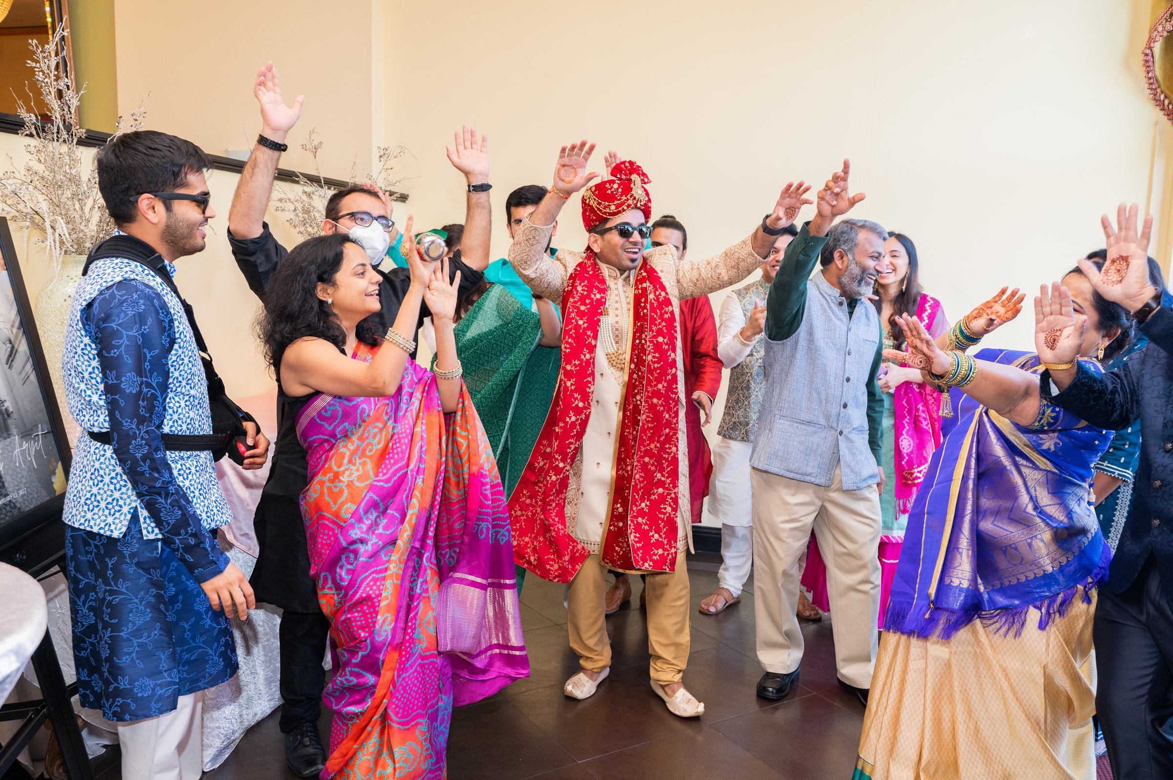 Ishita and arpit wedding groom dancing arms raised