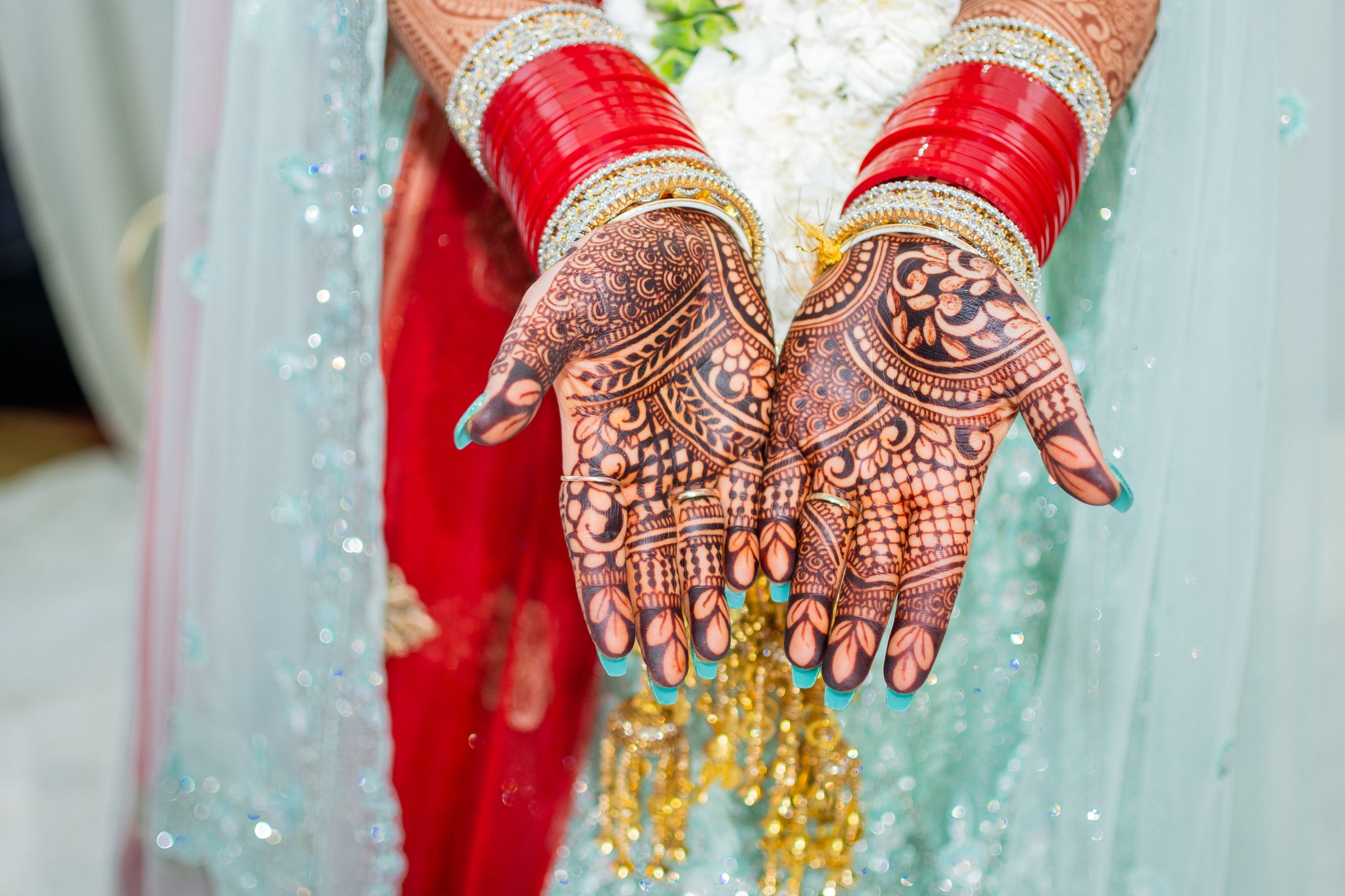 Niharika and mandar mehndi palms and red chooda