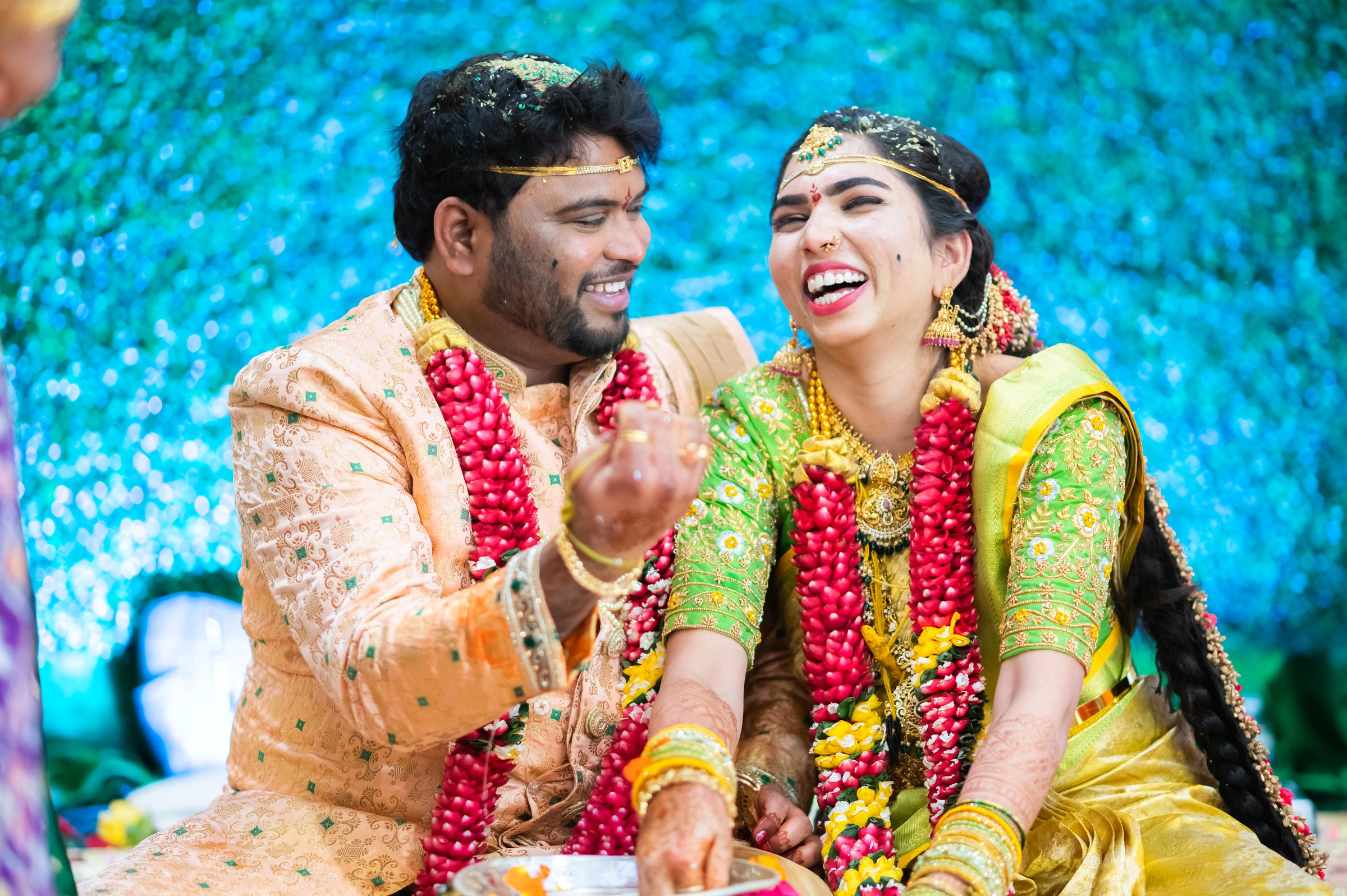 Vyshnavi and akhil couple laughing mid ritual